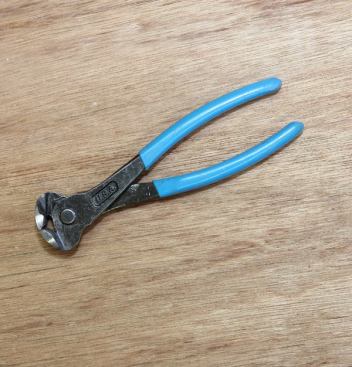 End Cutting Pliers  Carpenters often refer to these as Dykes (which is the brand of end cutting pliers everyone used to have). These are Channellocks. I use them daily for pulling brads and finish nails. They also are handy for cutting down screws or pulling and grabbing other items.