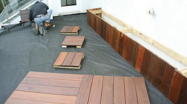 Vegetable planters and deck sections built with ipe were installed on top of the slip sheet.