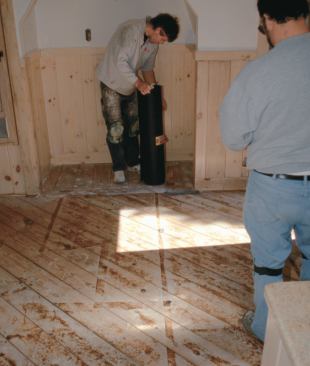 Although structurally suitable for tiling, this diagonally laid plank subfloor presented irregularities in plane that would telegraph through plywood underlayment and interfere with tile placement. A mortar base, or mud job, evens out the high and low spots, making an ideal tile bed.