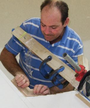 Pieces of scrap rail are used to test for fit and to set up the miter saw.