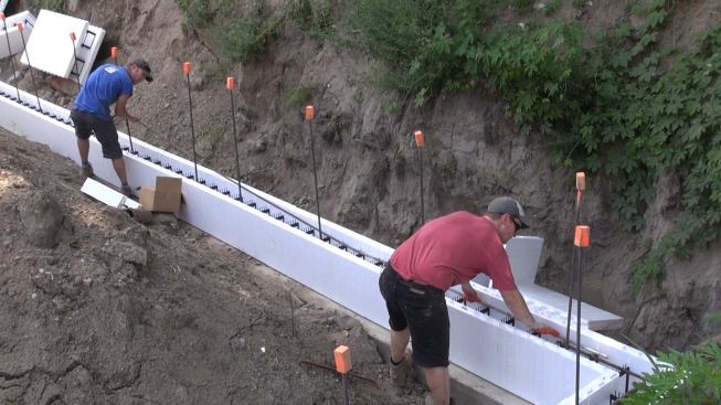 Steve Daly and Greg Hunt place another piece of rebar into the form.