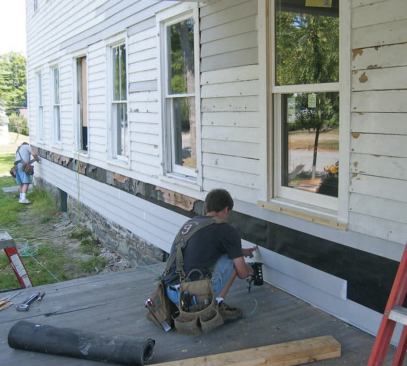 Carpenters removed the bottom clapboard courses and removed the rotted sills from the exterior, replacing them with built-up pressure-treated 2x8s. Then they fastened the new LVL rimboards to the built-up sills from the interior using GRK screws. (See the drawing "
Sill Retrofit " on page 4 of the PDF for more details.