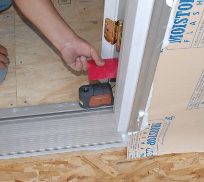 The most accurate way to check if a rough opening or installed door is plumb is with a laser.