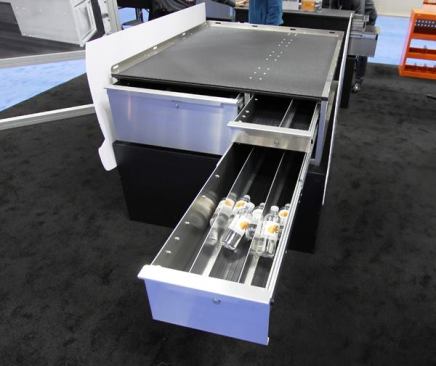 The EZSTOW is a drawer unit that mounts in the bed of a pickup. Made from thick aluminium with stainless steel hardware, it can be used alone or paired with the Sidekick unit shown in the previous photo. The top has a non-skid coating and a rim with tie-down points for securing cargo. Units come with one or three drawers; all are divided and contain rubber matting. EZSTOW is available in multiple heights for long and short beds in Ford, Dodge/Ram, and Chevy/GMC pickups. It’s made in the Chicago area and sells for between $1,800 and $3,000.