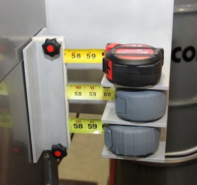 To demonstrate the tool’s resistance to dirt and grit Milwaukee attaches the tape to the side of a sandblasting case with the blades passing through the side of the enclosure. The Milwaukee is on top; the tapes below are competing models that have been painted gray to make them hard to identify.