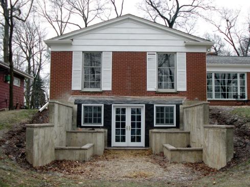 By adding the patio door and windows, the author made the interior space more livable and provided convenient access to the backyard and the lake beyond.