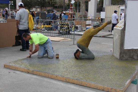 Oops, those coins are actually concrete—stained to look like gold. Oh well, the slot machine and the guy who is playing it are concrete too.