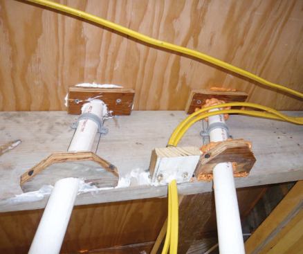 To provide a caulkable surface for sealing the drywall to the framing, backing plates fashioned from scrap lumber and plywood were fastened to the edges of framing members.