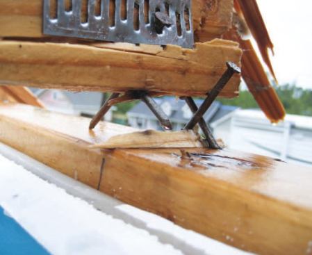 A closeup shows a typical truss-to-top-plate connection; the four toenails, placed in opposing pairs, caused the bottom chord to split.