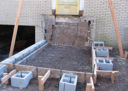 Once we had propped up the porch roof and cleared away the debris, we built forms for the two slabs that would support the upper and lower sets of stairs.