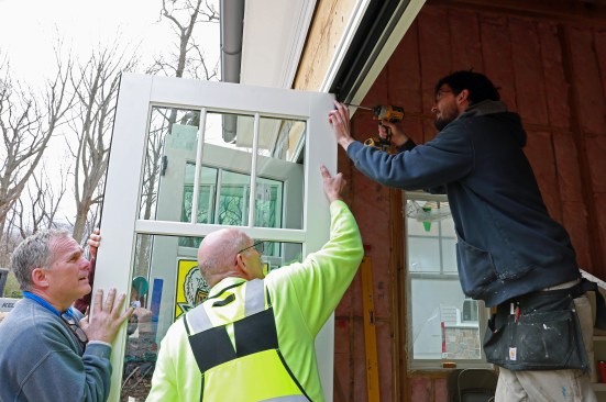 Above: The carrier hinge at the top is secured to the door with the supplied screws