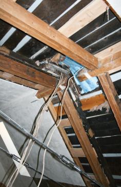 The upper ends of the chords butt to the sides of the existing ridge beams and are held in place with upside-down joist hangers.