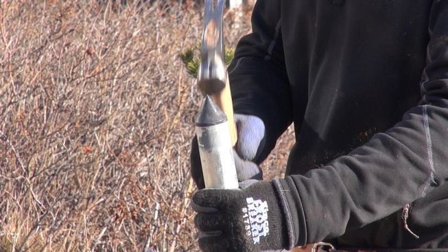 Horgan taps a hard plastic point into the end of on of the Diamond Pier’s four hollow galvanized steel pins.