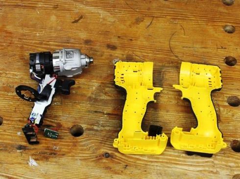 After peeling off the adhesive stickers that span the joint pull the housing apart and remove the mechanical parts.