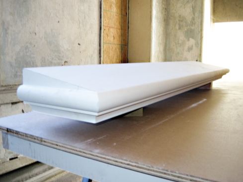 The replacement sills matched the profile of the originals; they came primed and cut to length, but the carpenters had to scribe and cut out the returns on site.