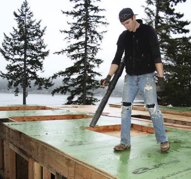 Zip tape can't be installed on wet surfaces, so a backpack leaf blower is used to dry off the seams in damp conditions.