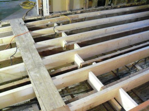 To stiffen the floor, I glued and screwed solid blocking between the joists in three separate spans across the floor, and I blocked every space between the new joists and the old joists.