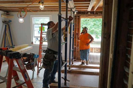 Flush beam. In preparation fro replacing the flush-framed beam, the crew erects shoring to hold up the joists.