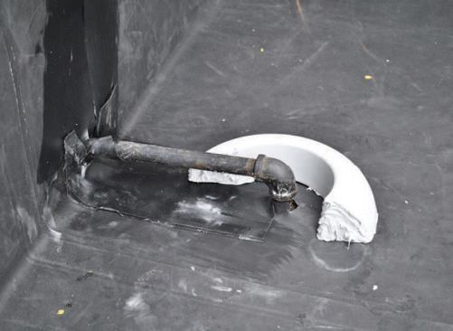 The author seals pipe penetrations with PVC donuts. First the donut is cut in half to fit around the pipe.