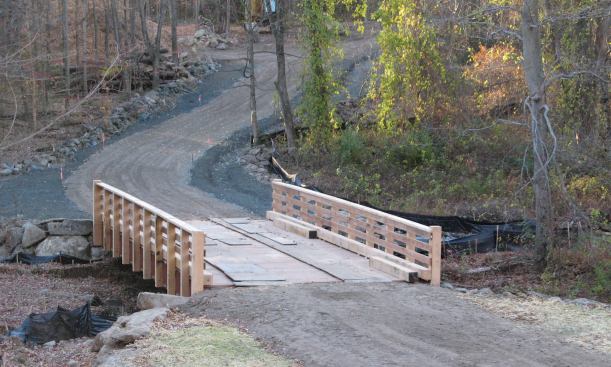 Intelligent reuse of old railcar beds enabled the author to construct an access driveway to cross a 38-foot span without damaging the stream below.