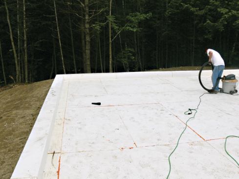 A carefully compacted bed of crushed stone provided a flat sub-base for the insulation directly under the slab.