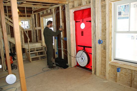 Harvey Johnson fires up the blower door and starts the test.