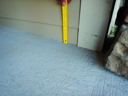 Again, MaxiPlank calls for 1 inch to 2 inches of clearance between siding and a sidewalk.