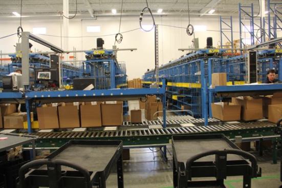 This is the shipping area. I wish I’d been able to shoot video of it in operation because the mechanism is kind of cool. It works like the clothes storage rack at a dry cleaner: When the operator needs a particular item he calls it up on a terminal, the rack rotates, and that item moves to the front where it’s easy to get at. The operator can then package the item and ship it out.
