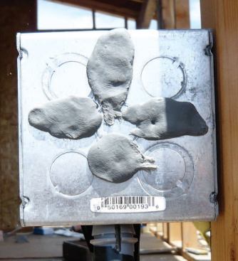 The holes through existing electrical boxes were plugged with a nonhardening putty designed for sealing ducts.