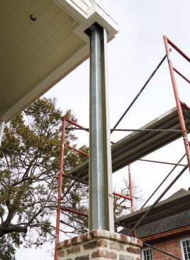 We created a brick pedestal to cover the lower part of the post, then concealed its upper portion with a 10-foot fiberglass column.