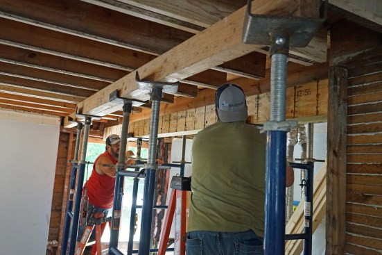 Flush beam. Ernesto and Toby use shoring to lift the new beam into place. 