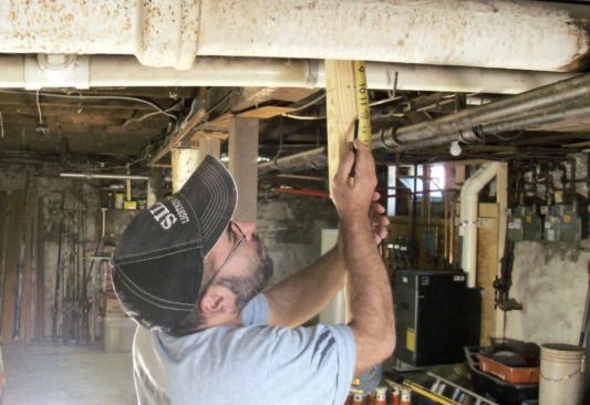 Before doing anything else, I want to get a sense of how badly the girder is sagging. So I run a string 12 inches below the bottom of the joists from one end of the basement to the other.