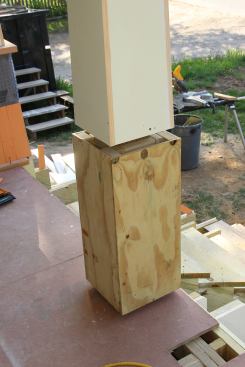 The base of the porch columns are boxed out with treated 2x4 blocking and treated plywood.