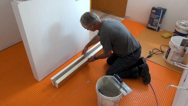 Boucher lays the mortar-covered Kerdi-Board pieces together.