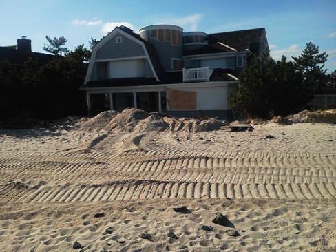 Sandy's storm surge broke open the house's doors and buried the first floor in three feet of sand, says Eric Borden.
