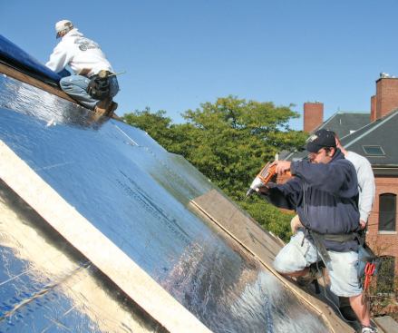 The screws are driven through the sheathing into the rafters.