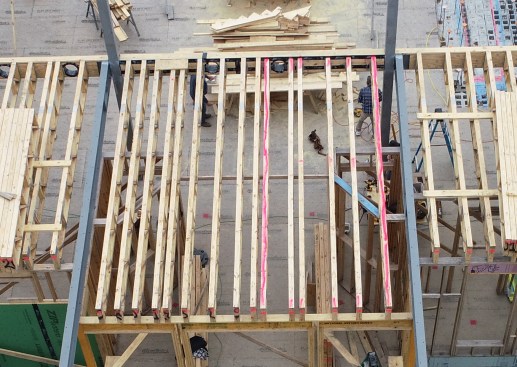 At an area where trusses drop for a curbless shower, the author painted the top chords hot pink so framers stayed aware of the small change in elevation.