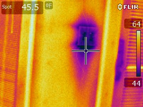 Similarly, the purple and pink spots on this thermal image of a light switch in an exterior wall show the cold areas due to poor insulation and air-sealing.