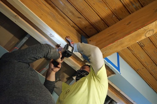 The tapered strips will provide a level surface against which they could place the new steel beam.