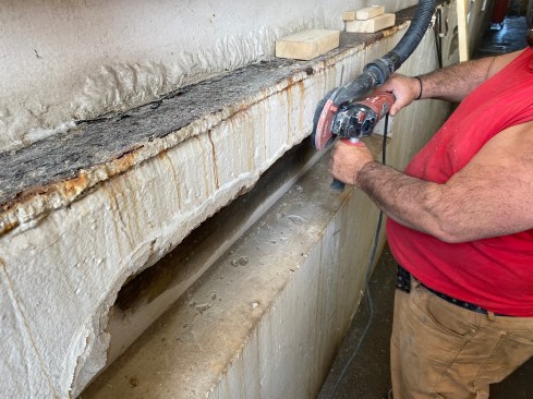 The crew also used a grinder to remove the old paint in the area where the new concrete meets the existing surface. 