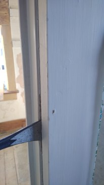 Gently pry at the seam, just enough to loosen any nearby nails. When you relax pressure on the prybar, the extended nail will push out the small plug of filler, revealing the nail's location.