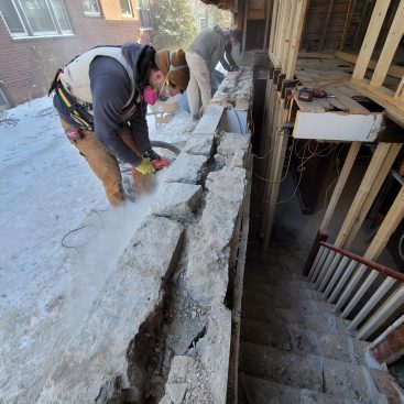 The foundation is solid below-grade; only the top two courses of stone had come loose. The crew sets to work cutting out the crumbled mortar in preparation for reinforcing steel and non-shrinking grout