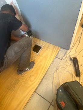 New floor sheathing and backerboard completes the rejuvenated shower area.