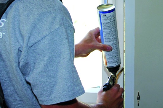 Sealing with foam. On this window, foam is applied  on both sides and across the head. The carpenter started at the upper  right corner and pulled a bead down the right side of the window.