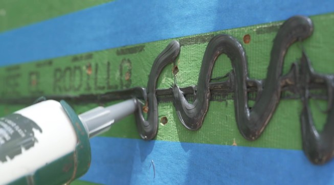 The next zig-zag pass applies enough sealant to lay down a thick bed.