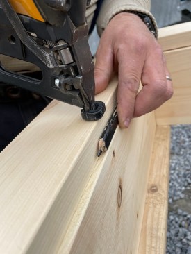 A carpenter’s pencil makes a ready gauge for the casing reveal.