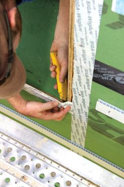 Because the air control layer of the building is at the exterior skin, including the windows, all of the seams in the window buck and window opening are taped using Siga Wigluv tape. The outboard window faces are taped to the OSB—tape is applied first to the sill.