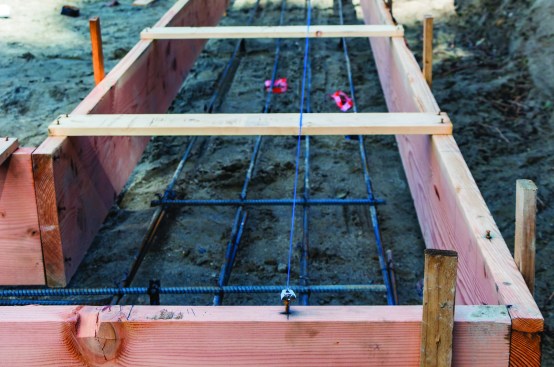 To ensure exact placement of footings, the author tacked a nail and strung a line to mark the outside of the foundation wall.
