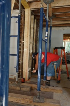 Flush beam.  A built-up column provides full bearing for one end of the flush beam. The base of the column bears on the new beam that was installed in the basement, which in turn is carried by the main girders. 
