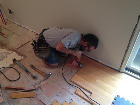 After rough cutting the boards, Manny finishes the work of the circular saw with an oscillating tool. Note at this point that he still has to cut two of the three boards to the length he marked out before, and needs to remove the middle board back to an existing seam.